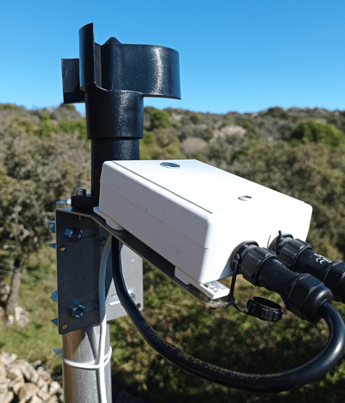 CloudWatcher and anemometer installed outdoors on a pole, cable pointing downwards