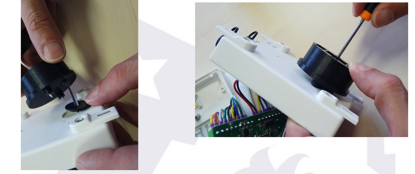 The sensor being screwed firmly into place from both inside and outside the box
